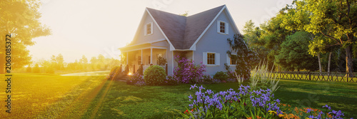 Sunlit country house with garden at golden hour