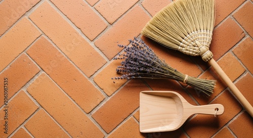 Broom and dustpan on tile floor.