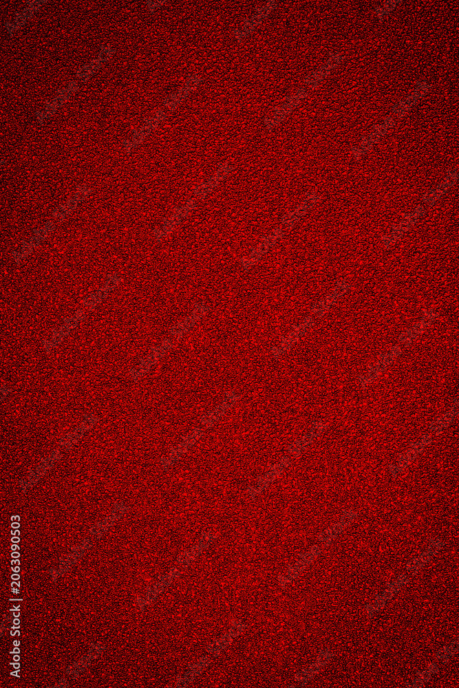 Fototapeta premium Bright red texture covers a surface, showing a smooth and uniform appearance in the center of a space