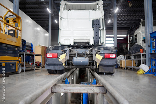 This image captures a modern truck positioned on a maintenance pit, showcasing the best practices in vehicle care and mechanical evaluations that are vital in today automotive industry.