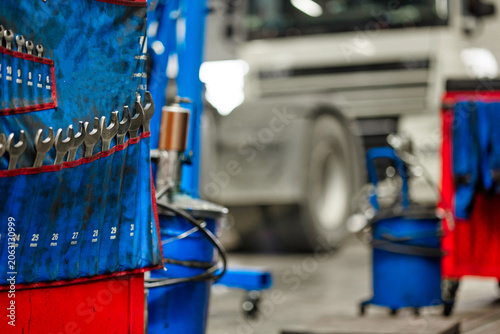 This image features a variety of professional wrenches hanging neatly in a truck service garage. Perfect for showcasing tools essential for mechanics and automotive services.