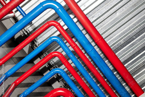 A colorful network of blue and red heating pipes, showcasing the intricacies of modern heat and water systems. This image emphasizes the vibrant design and functionality of plumbing infrastructure.