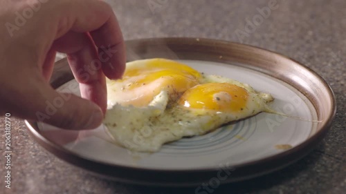 hot and steaming fried eggs on a plate for breakfast