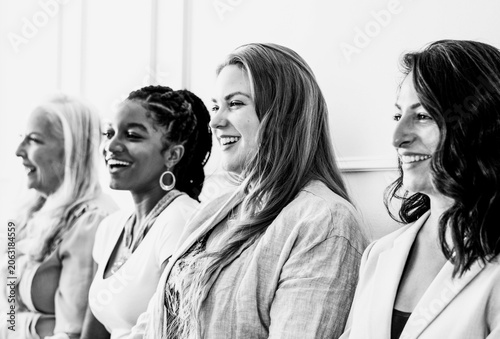 Fényképezés Diverse women smiling in a row, black and white photo