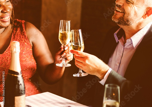 Tableau sur toile Joyful celebration with champagne toasts at dinner