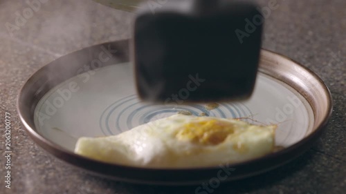 hot and steaming fried eggs on a plate for breakfast