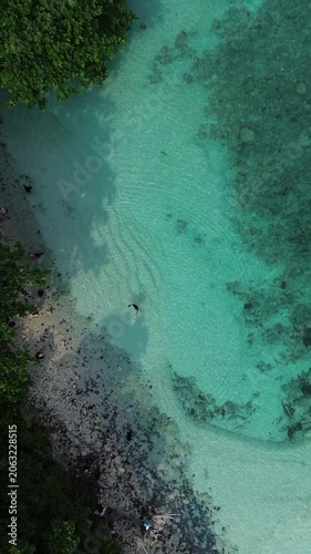 Top Down Aerial Of Turquoise Reef Lagoon With Lone Swimmer