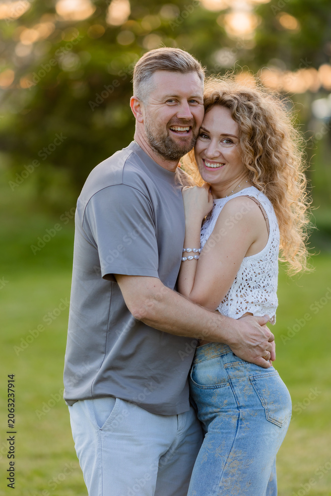 Fototapeta premium couple of man and woman hugging in the summer in a city park