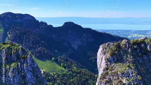 4K Drone Flight Over Rocky Cliffs Above Forested Alpine Valley