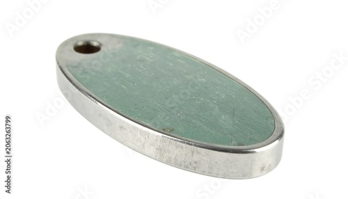 Close up of an Oval Metal Tag Showing Text and Design Details