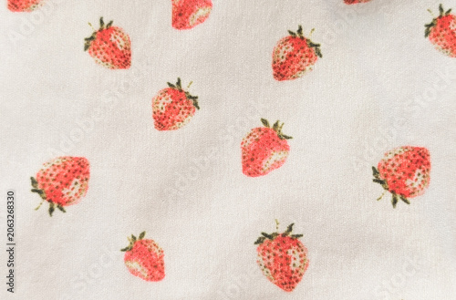 close up of strawberry fruit print on white fabric texture