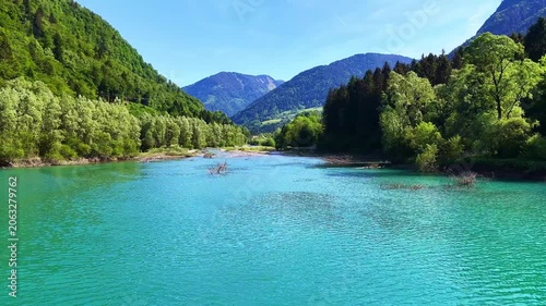 4K Drone Flight Over Turquoise River Through Forested Mountain Valley