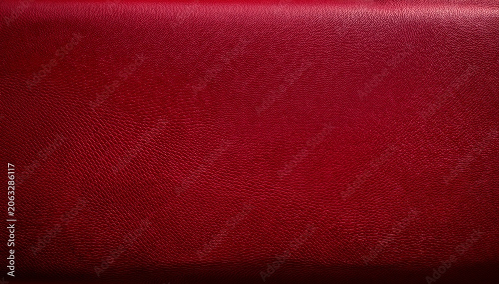 Fototapeta premium a textured close up of a deep red surface the texture shows subtle variations in tone creating a rough tactile impression light