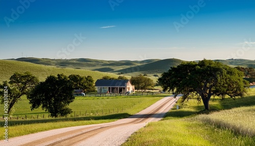 picturesque country road with a house in the background against rolling hills of marble falls texas