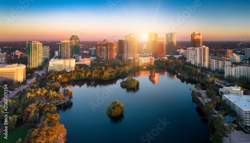 aerial view of lake eola and the orlando city skyline at sunrise