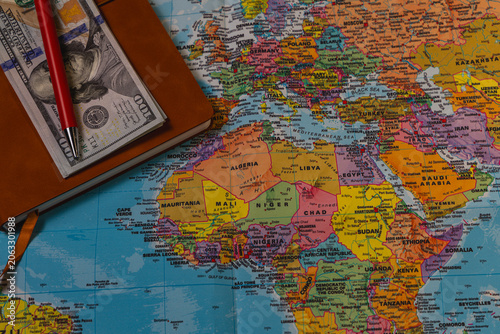 Planning travel with a world map, passport, and travel accessories ready
