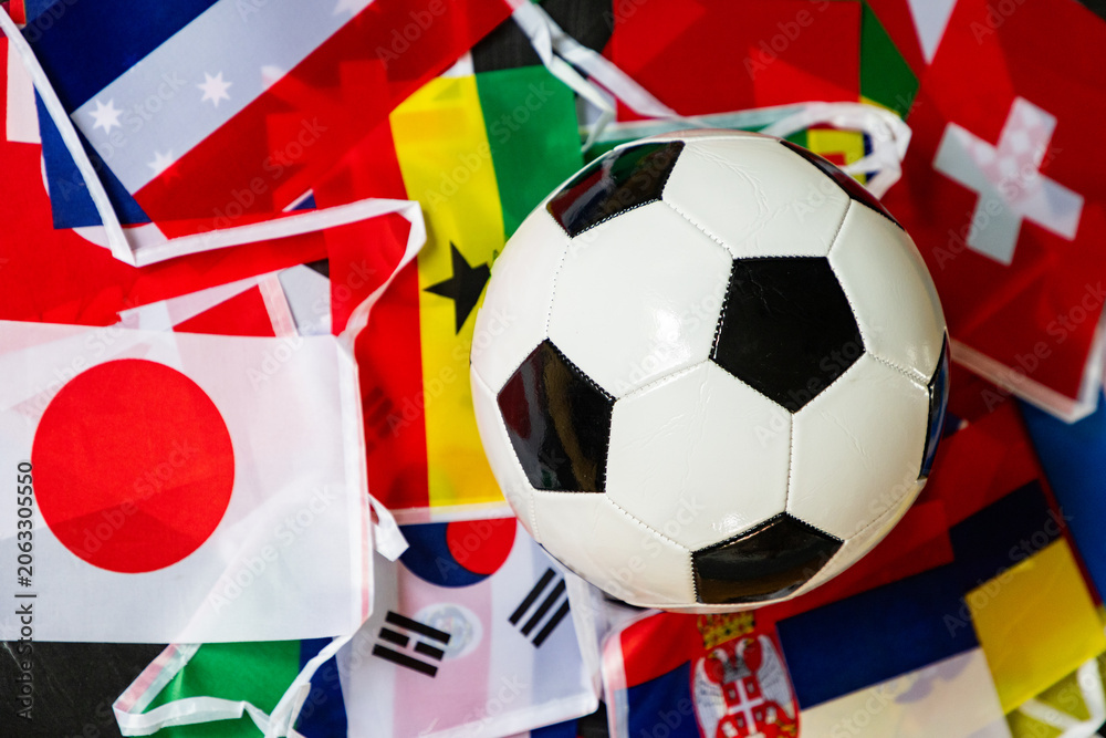 Fototapeta premium classic black and white soccer ball on world flags