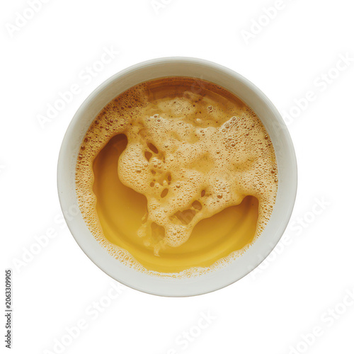 A top-down view of a white ceramic bowl filled with golden yellow liquid topped with a thick layer of bubbly foam, isolated on white