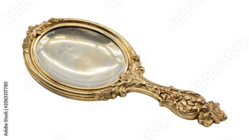 Ornate gold hand mirror with a polished reflective surface and intricate floral carvings on the handle isolated on a solid