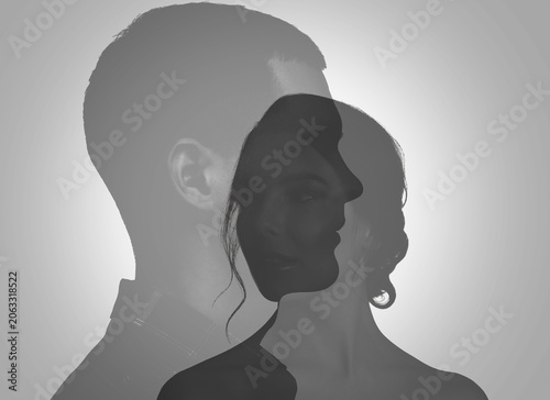 фотографія Silhouettes of man and woman on light grey background