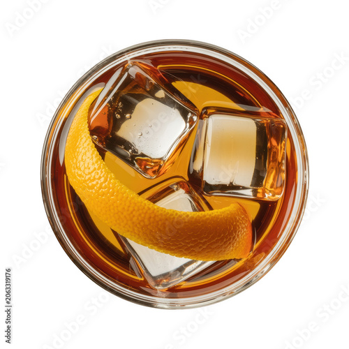 Overhead view of a glass containing a dark amber alcoholic drink, large square ice cubes, and a single orange peel twist on a white background