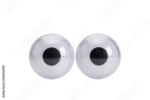 Pair of plastic googly eyes with white background, and black pupils, isolated on a, black background, macro, shot of craft, supply accessories