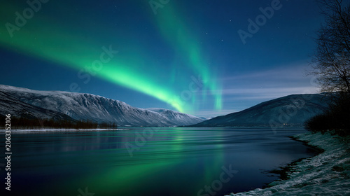 Northern Lights Over Snowy Mountain Lake