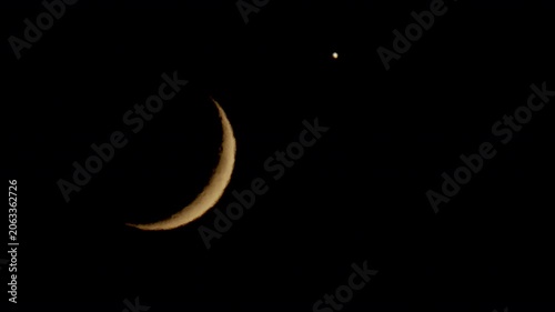 The partial Moon and Venus move slowly across the night sky on June 17, 2026.