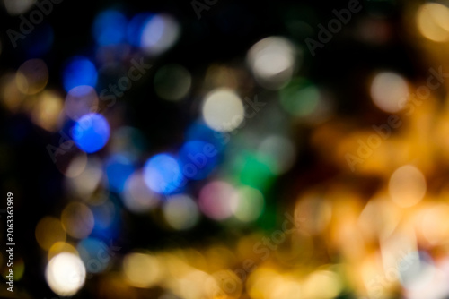 defocused bokeh light orbs in blue and golden hues. celebratory or holiday-themed background. Christmas or New Years banner.