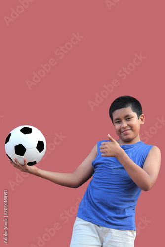 12-year-old Latino boy with dark skin plays with his soccer ball to practice for the game 
