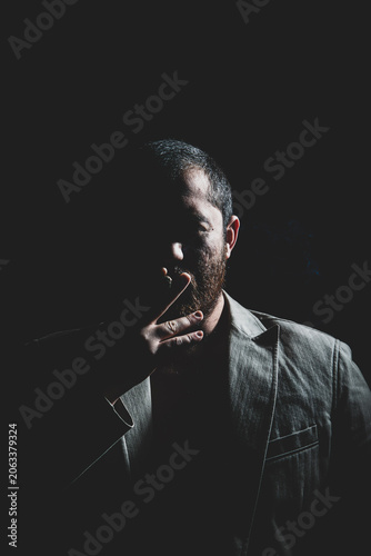 Bild auf Leinwand Man Smoking Cigar in Cinematic Studio Lighting