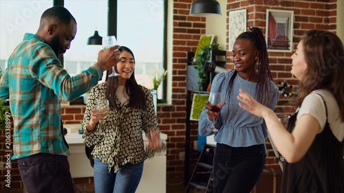 Photos Group of friends dancing at apartment party, having fun together, moving their feet on rhythm