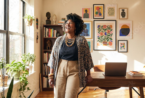 Portrait of happy confident black woman in her home office space