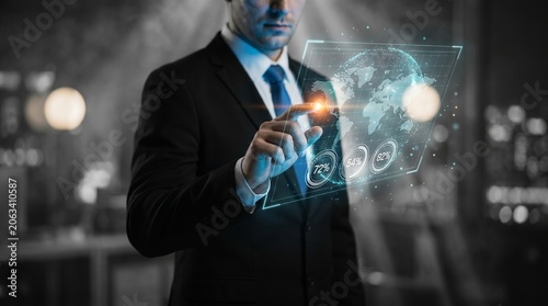 Businessman analyzing digital data hologram in futuristic office with neon lighting
