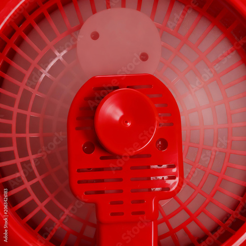 close up of a bright red rotating electric fan generated by AI