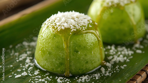 Green Mousse Dessert with Coconut Flakes and Syrup on Banana Leaf