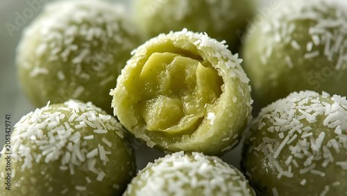 Healthy Green Energy Balls with Coconut Flakes, One Cut Open Showing Filling
