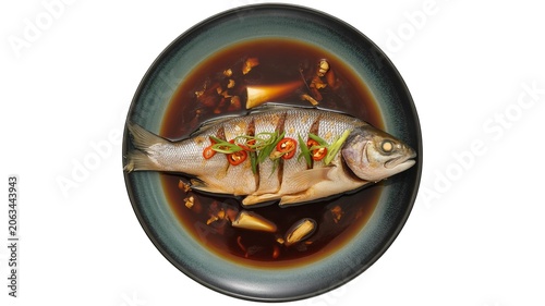 Cooked whole fish with chili herb garnish served in soy garlic sauce Asian cuisine traditional seafood meal food photography