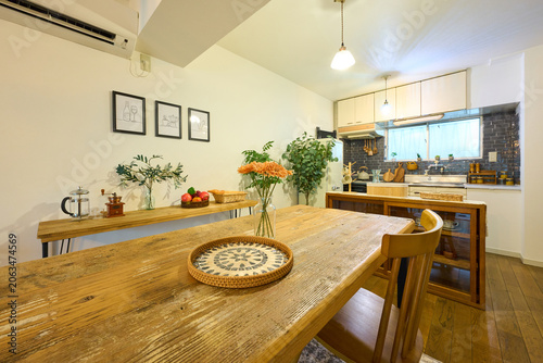 Wooden dining table and chair in cozy kitchen interior with natural light