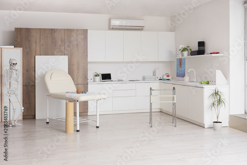 Modern physical therapy and rehabilitation clinic interior with examination t...
