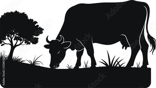 Foto Silhouette dairy cow grazing peacefully in lush green grass beside a solitary tr