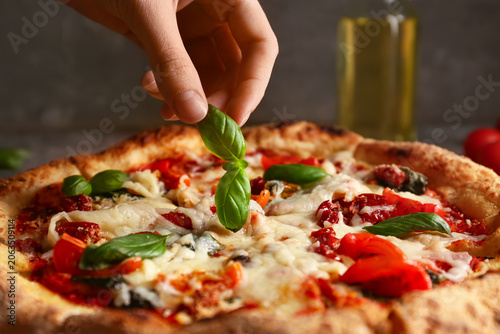 Hand with basil and tasty p...
