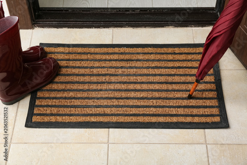 Brown door mat, umbrella an...
