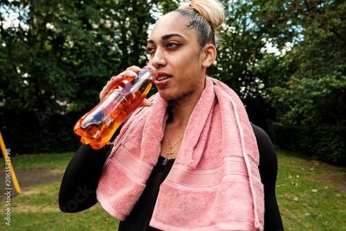 Photos Woman drinking energy drink after fitness workout