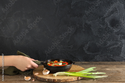 Woman holding frying pan wi...
