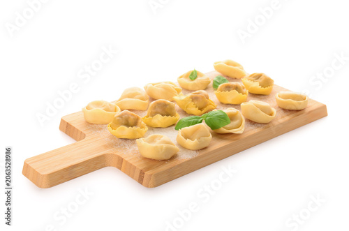Wooden board with raw dumpl...