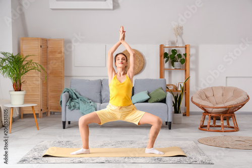 Young woman doing yoga  at ...