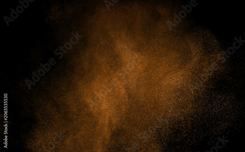 Foto Abstract brown dust particles floating on black background