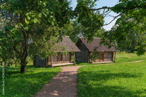 Log buildings of granaries in the Novgorod Museum of Folk Wooden Architecture Vitoslavlitsy on a sunny summer day, Veliky Novgorod, Russia