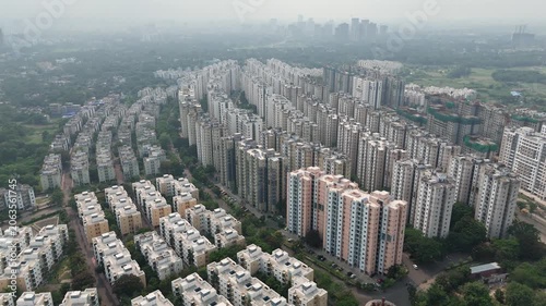 A striking aerial drone perspective of rows of newly constructed high-rise residential towers by the Shapoorji Pallonji Group in Kolkata, West Bengal, India.